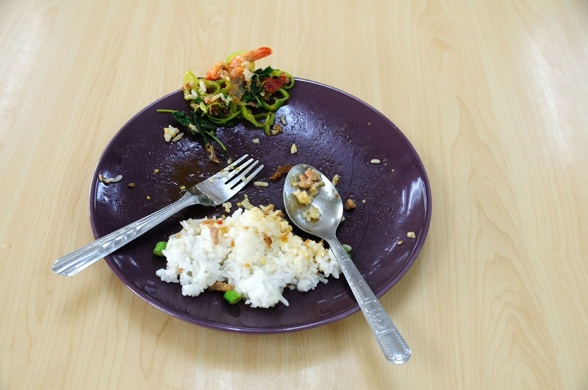 64122658 - food waste in plate on wooden table.